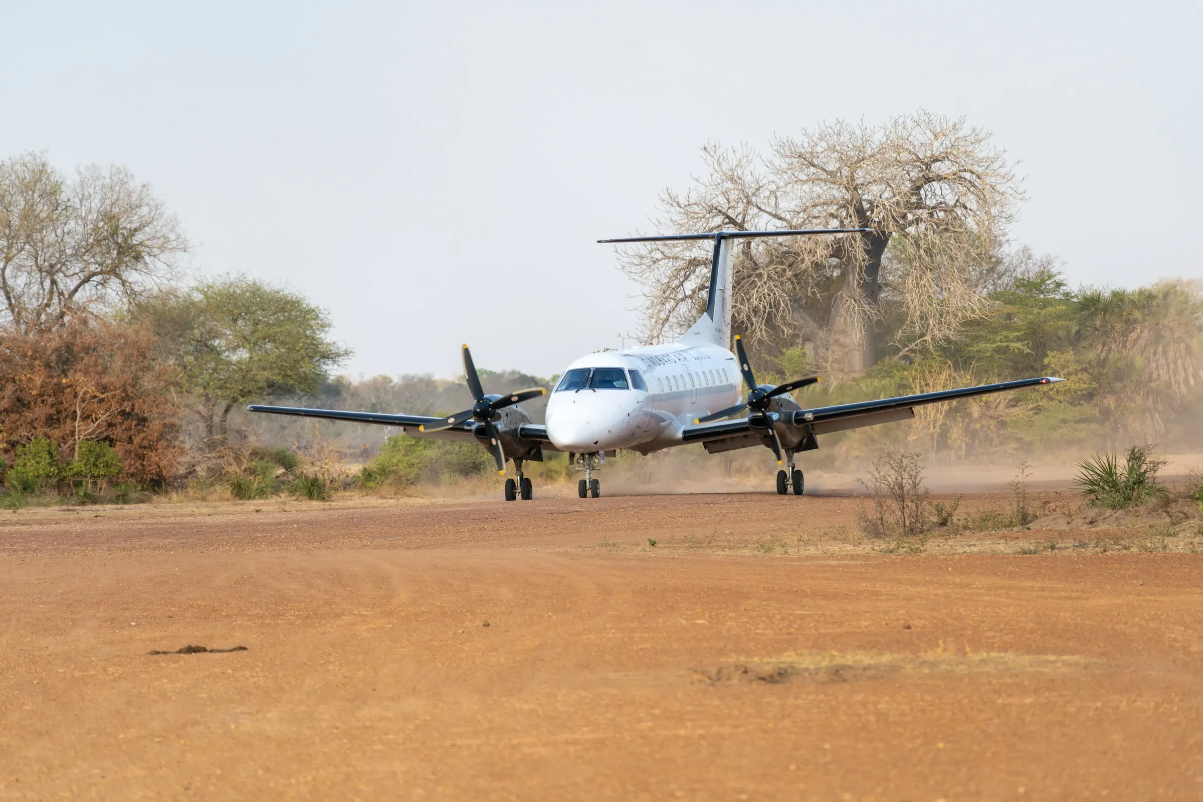 A twin turboprop on a dirt airstrip in the bush